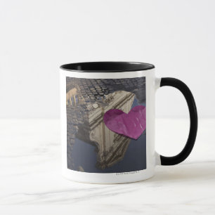 Lonely paper heart floating in a puddle. mug