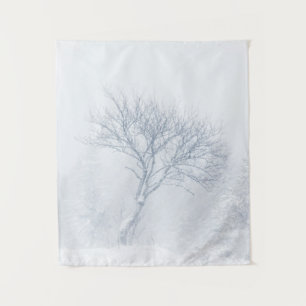 Lonely tree during snow storm in winter tapestry