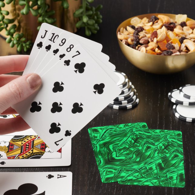Long curved strokes forming star on green metallic playing cards (In Situ)