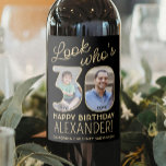 Look Who's 30 Black & Gold 2 Photo Birthday Party Wine Label<br><div class="desc">Look who's 30! Add an elegant personalized touch to 30th birthday party decorations for him or her with custom photo black and gold wine bottle labels. The pictures and wording on this template are simple to customize. (IMAGE PLACEMENT TIP: An easy way to position a photo exactly how you want...</div>