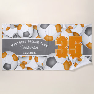 Lots of soccer balls orange grey team colours beach towel