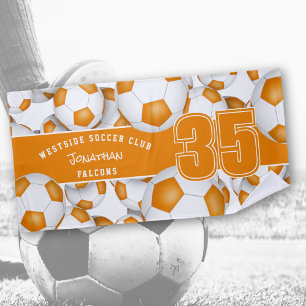 Lots of soccer balls orange white team colours beach towel