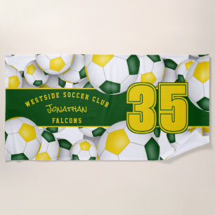 Lots of soccer balls with green gold team colours beach towel
