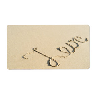 Love carved sign on the beach sand