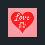 Love Lives Here Message Canvas Print<br><div class="desc">An upbeat message that says "Love Lives Here". Red and Pink colour theme with a large heart as the main motif. Sign for a happy home.</div>