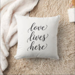Love Lives Here Script Throw Pillow<br><div class="desc">Create a warm and meaningful space with this elegant “Love Lives Here” wall art. Designed in a clean script typography style,  this minimal black and white print adds a timeless touch to any home.Throw Pillow</div>