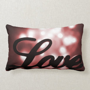Love sign with red sparkle lights behind lumbar pillow