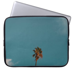 Low angle photography of palm tree under blue sky laptop sleeve