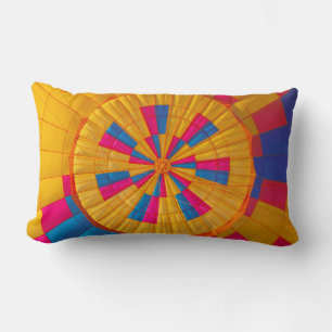 Low angle photography of yellow, pink, and black h lumbar pillow