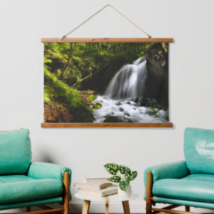 Magical waterfall in enchanting green forest hanging tapestry
