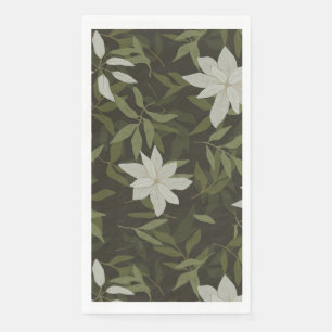 Magnolia and green leaves on black napkin