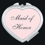 Maid of Honour Compact Mirror<br><div class="desc">Compact mirror shown in a heart shape with a blush pink background colour with Maid of Honour text in black.
Customize this item or buy as is.</div>