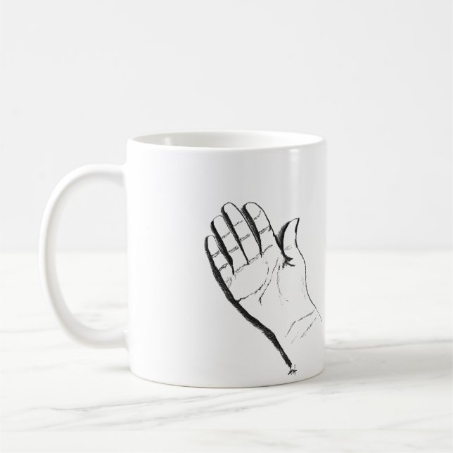 main noire et blanche sur une tasse à café (Gauche)