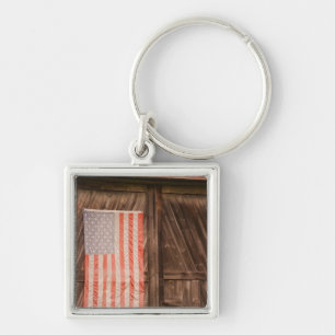 Maine, Faded American flag on door of old barn Keychain