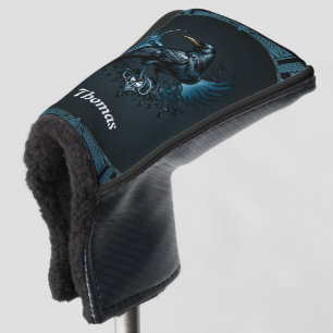 Majestic black raven sitting on an ornate golf head cover