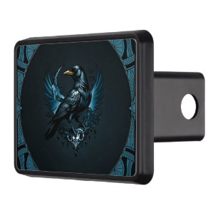 Majestic black raven sitting on an ornate trailer hitch cover