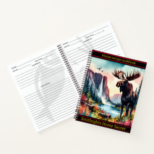 Majestic moose standing by a serene mountain lake notebook