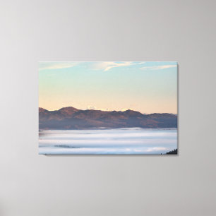 Majestic mountain Triglav with fog in valley Canvas Print