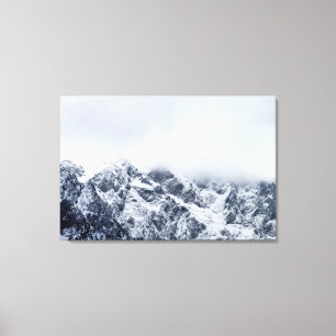 Majestic mountains below clouds canvas print