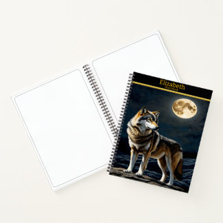 Majestic wolf howling at the luminous moonlight notebook