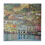 Malcesine on Lake Garda By Gustav Klimt Tile<br><div class="desc">Malcesine on Lake Garda (1913) by Gustav Klimt is a vintage Victorian Era Art Nouveau fine art symbolism painting. A beautiful view of the Italian city of Malcesine with buildings and houses on the edge of the harbour. The homes and boats cast a reflection in the calm water. You can...</div>