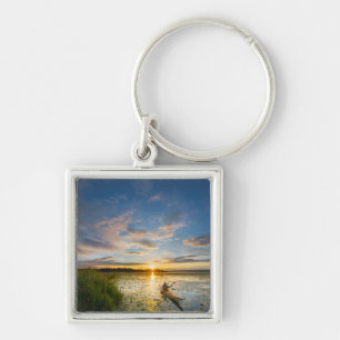 Male kayaker paddling sea kayak on still water keychain