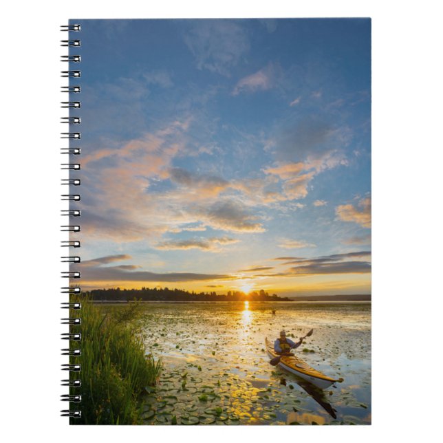 Male kayaker paddling sea kayak on still water notebook (Front)
