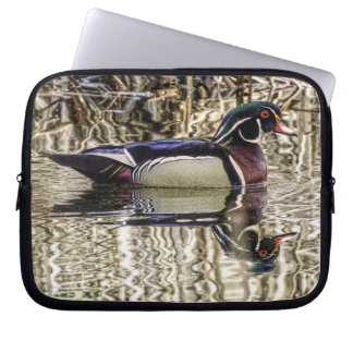 Male wood duck swimming in pond laptop sleeve