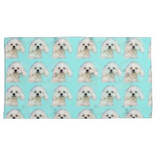 Maltese puppy on blue pillowcase