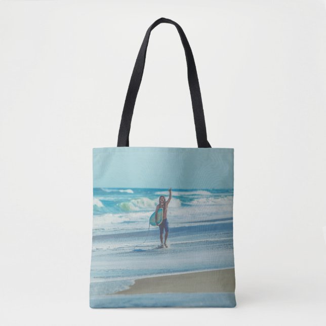 Man carrying surfboard at beach tote bag (Front)