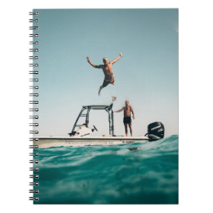 Man diving on pool notebook