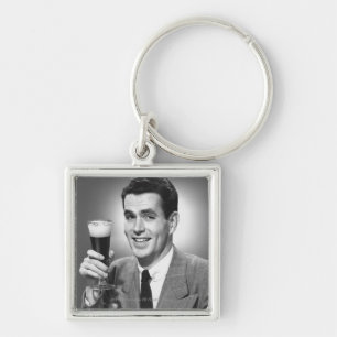 Man holding glass of beer in studio B&W Keychain