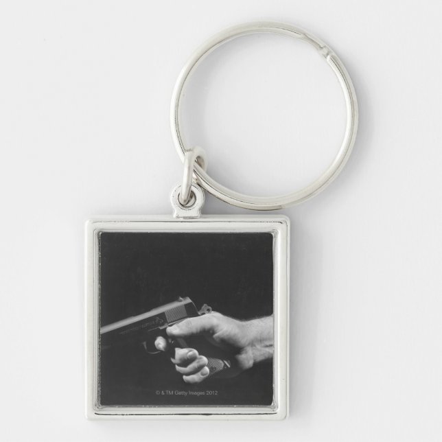 Man Holding Gun Keychain (Front)