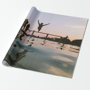 Man jump in mid air on body of water wrapping paper