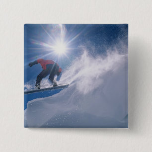 Man jumping off a large cornince on a snowboard 2 inch square button