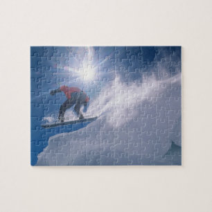 Man jumping off a large cornince on a snowboard jigsaw puzzle