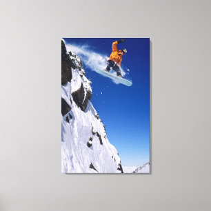 Man on a snowboard jumping off a cornice at canvas print