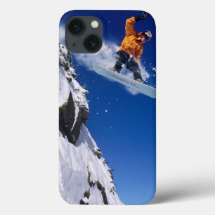 Man on a snowboard jumping off a cornice at iPhone 13 case