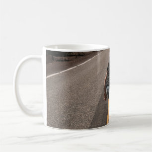 Man playing skateboard on road in the morning coffee mug