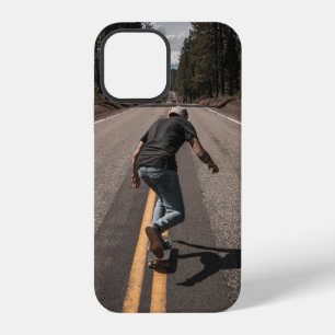 Man playing skateboard on road in the morning iPhone 12 case