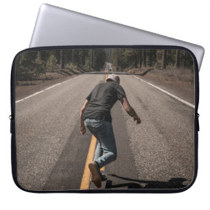 Man playing skateboard on road in the morning laptop sleeve