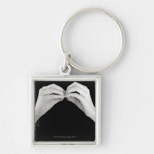 Man signing letter b in British sign language, Keychain