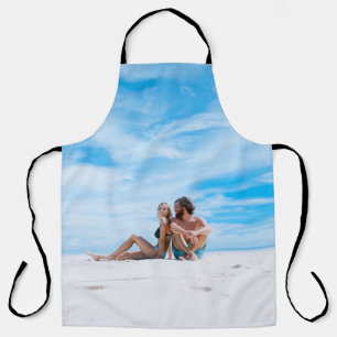 Man sitting beside of woman in black bikini top apron