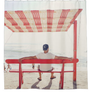 Man sitting on bench near beach