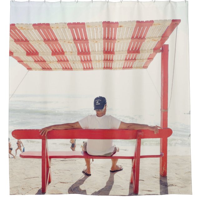 Man sitting on bench near beach (Front)
