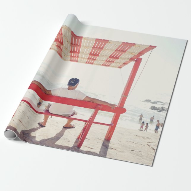Man sitting on bench near beach wrapping paper (Unrolled)