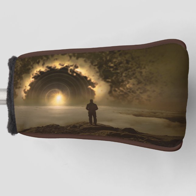 Man standing on a hill looking at a large  golf head cover (Front)