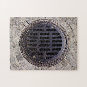 Manhole cover and cobblestone road jigsaw puzzle