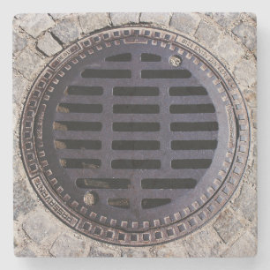 Manhole cover and cobblestone road stone coaster