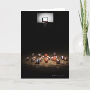 Many basketballs resting on the floor card